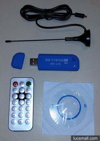 "The USB DVB-T dongle as it arrived: the blue dongle, antenna, remote and disc with software"